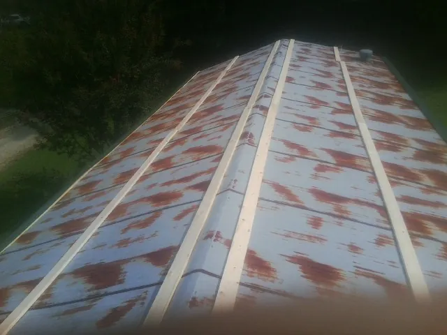 Rusted metal roof panels with new wood purlins before replacement — Storm Damage Roof Repair in Lake Junaluska by Roofing Brothers