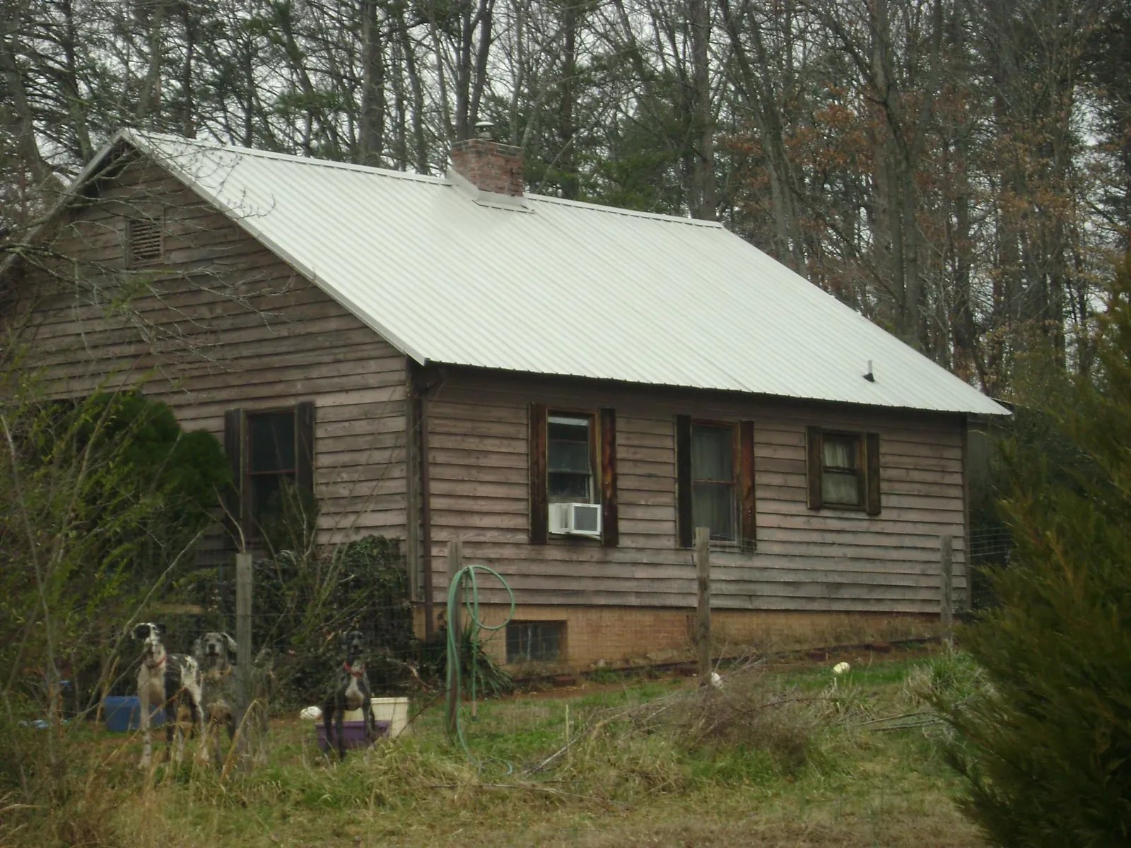 White metal roof on an old wood sided farmhouse, from a Metal Roof Installation job in Lake Junaluska